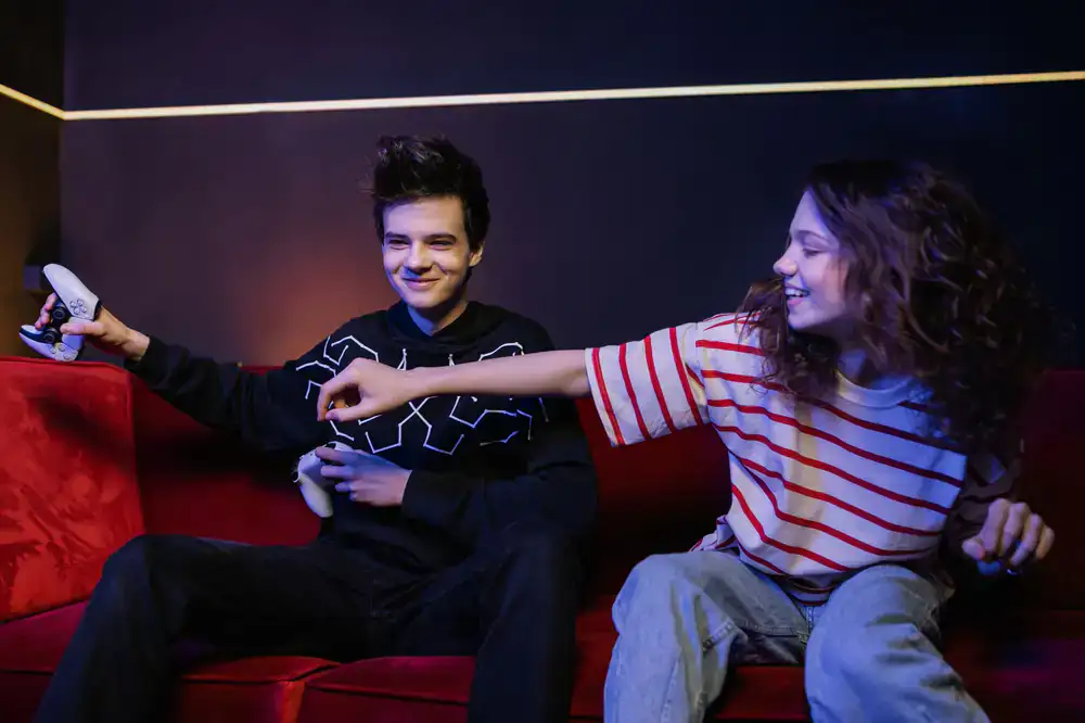 Two gamers having an engaging discussion while testing a new indie title