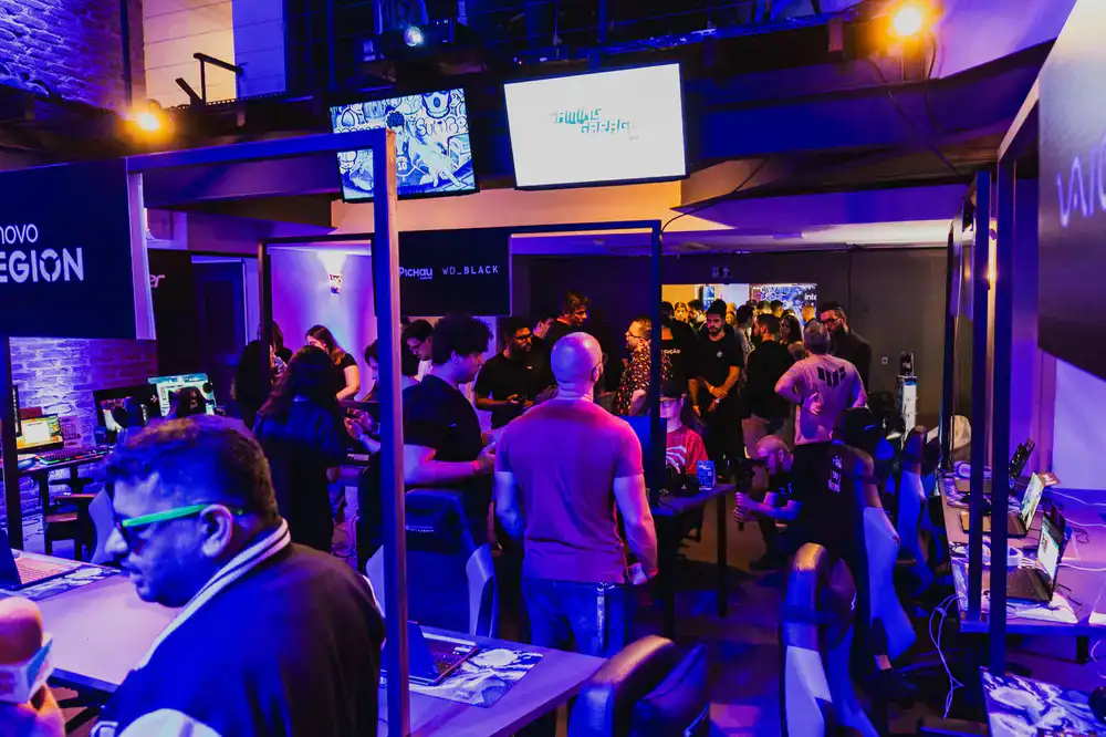 Developers and players interacting at a lively indie game setup
